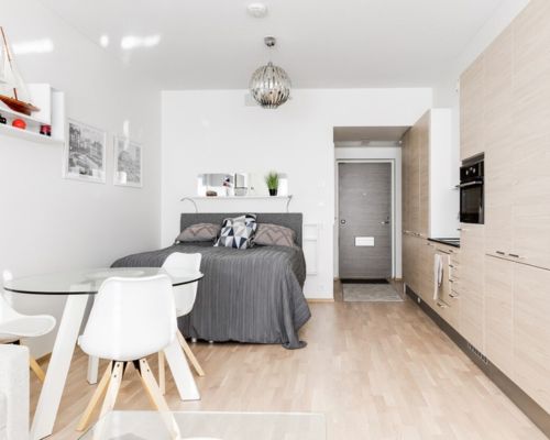 Living room and dining area in a furnished rental in Tampere